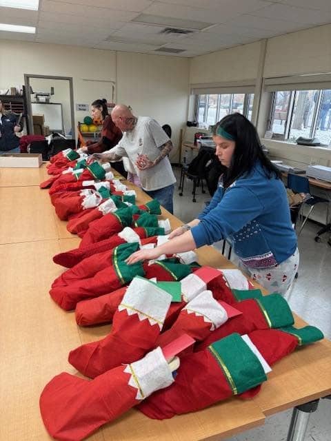 Volunteer Elves sorting and assembling stockings at Elf Headquarters